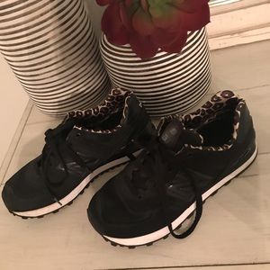 Black New Balance with a little leopard shoes.